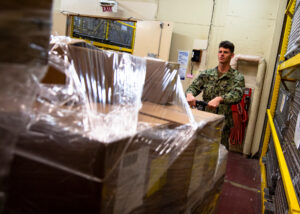 Caption: Logistics Specialist Seaman Allan Teschner, from Northport, Fla., receives medical supplies aboard the hospital ship USNS Mercy (T-AH 19), March 29, 2020. (U.S. Navy photo by Mass Communication Specialist 2nd Class Ryan M. Breeden/Released)